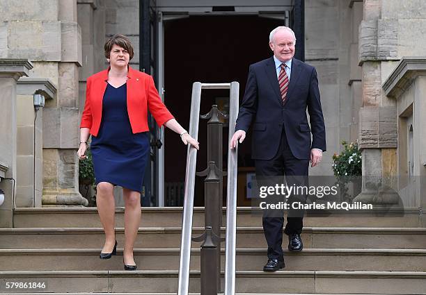 Arlene Foster and deputy first minister Martin McGuinness wait to greet Prime Minister Theresa May at Stormont on July 25, 2016 in Belfast, Northern...