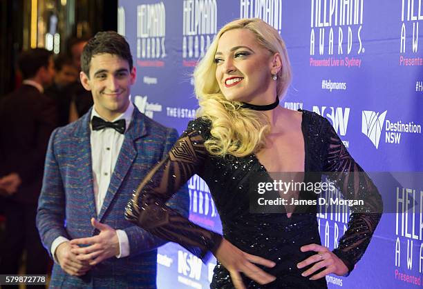 Gretel Scarlett is watched by Jack Chambers as they arrive ahead of the 16th Annual Helpmann Awards at Lyric Theatre, Star City on July 25, 2016 in...