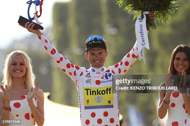 Poland's Rafal Majka celebrates his polka dot jersey of best climber on the podium on the Champs-Elysees avenue in Paris, at the end of the 113 km...