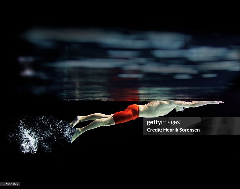 Male swimmer at the water surface