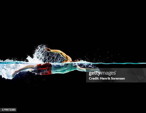 male swimmer in front crawl - swimmer athlete stock pictures, royalty-free photos & images