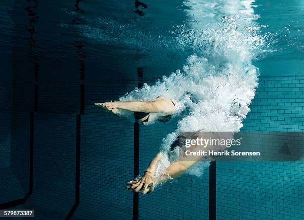 2 swimmers diving - diving into water stock pictures, royalty-free photos & images