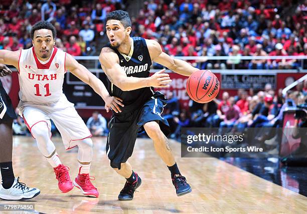 Colorado Buffaloes guard Askia Booker drives past Utah Utes guard Brandon Taylor during a game between Colorado and Utah. Utah defeated Colorado...