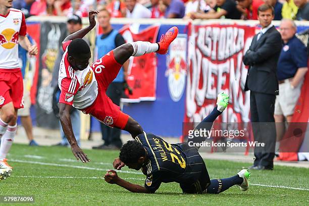 New York Red Bulls defender Kemar Lawrence gets upended by Philadelphia Union defender Sheanon Williams during the first half of the game between the...