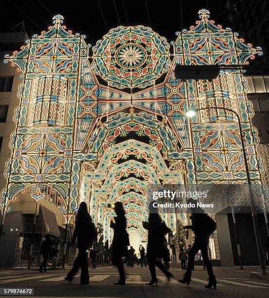 Japan - People look at some of the ''Luminarie'' illuminations in Kobe, Hyogo Prefecture, in western Japan, on the night of Nov. 28 after they were...