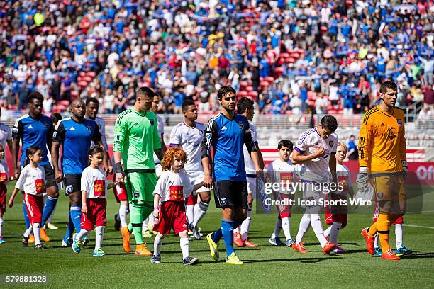 Both teams enter the field, lead by San Jose Earthquakes forward Chris Wondolowski and Orlando City FC goalkeeper Tally Hall , before the game...