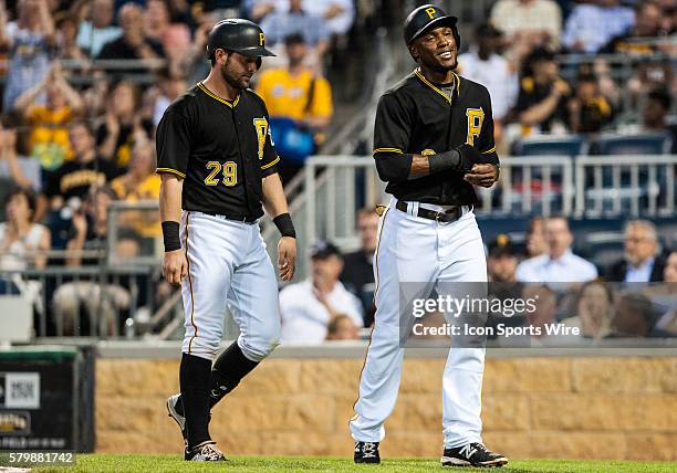 Pittsburgh Pirates left fielder Starling Marte walks back to the dugout with catcher Francisco Cervelli after scoring on an RBI single by first...