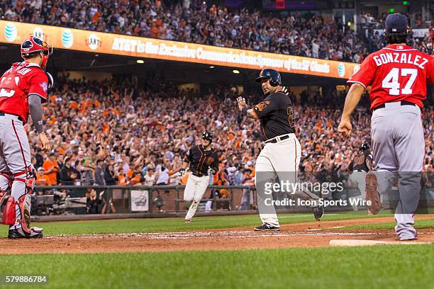 San Francisco Giants catcher Hector Sanchez comes home to score off a 3-run double by San Francisco Giants third baseman Matt Duffy in the 3rd...