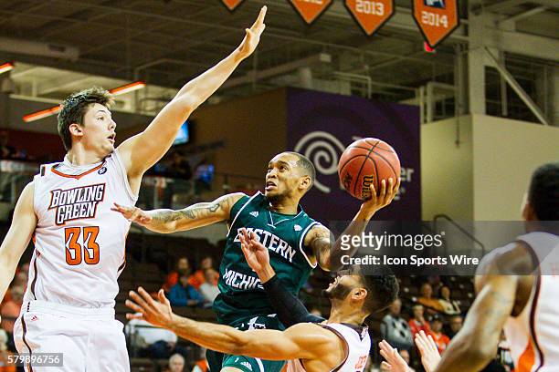 Eastern Michigan Eagles guard Mike Talley goes in for a layup against Bowling Green Falcons forward Garrett Mayleben during a Mid-American Conference...