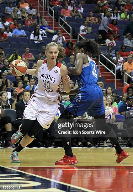 Washington Mystics center Emma Meesseman dribbles past Minnesota Lynx forward Devereaux Peters during a WNBA game at Verizon Center, in Washington...