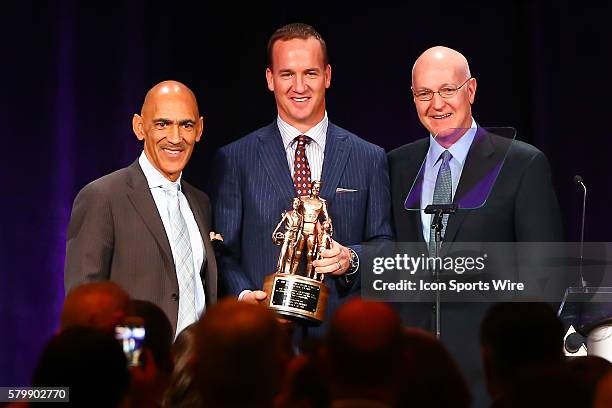 The 2015 Bart Starr Award is given to Peyton Manning by Tony Dungy and Bart Starr Jr during the 28th Annual NFL-Sanctioned Super Bowl Breakfast. The...