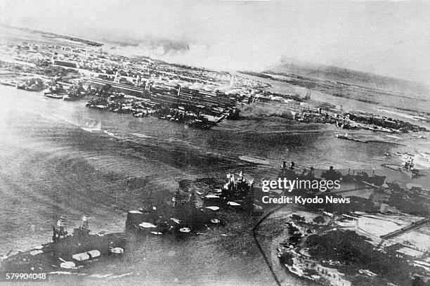 Pearl Harbor, HI - The file photo taken on Dec. 7, 1941 shows the U.S. Naval base in Pearl Harbor under attack by the Imperial Japanese Navy.