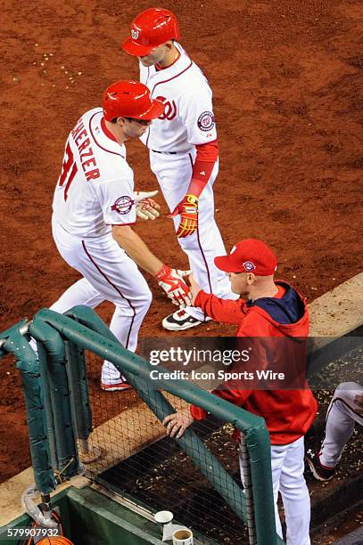 Washington Nationals starting pitcher Max Scherzer is congratulated by manager Matt Williams after scoring at Nationals Park in Washington, D.C....