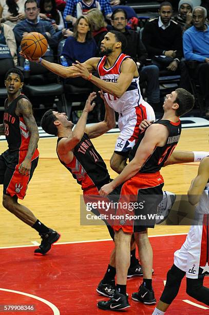 Washington Wizards guard Garrett Temple is called for an offensive foul against Toronto Raptors guard Greivis Vasquez at the Verizon Center in...