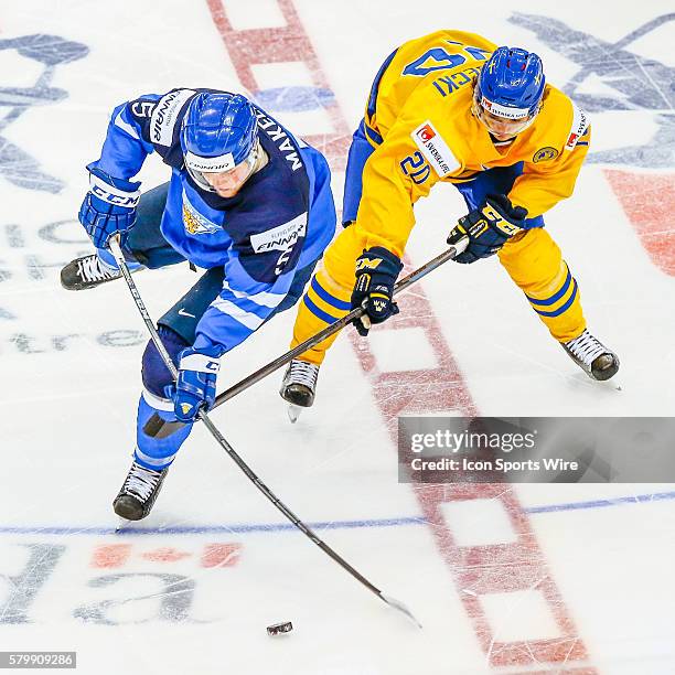 Alekski Makela of Finland fights for the puck with Adam Brodecki of Sweden during Sweden's 6-3 victory over Finland at the IIHF World Junior...