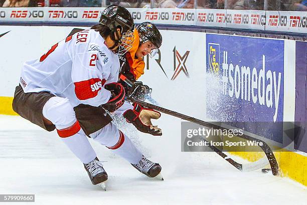 Jonas Siegenthaler of Switzerland fights for the puck against Germany during Switzerland's 5-2 victory over Germany at the IIHF World Junior...