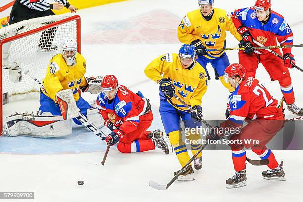 Pavel Buchnevich , Alexander Sharov , and Alexander Dergachyov of Russia fight for puck against Victor Olofsson , Robert Hagg , and Linus Soderstrom...