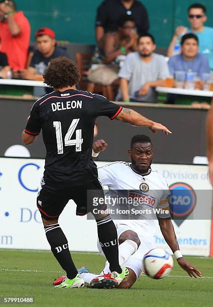 Philadelphia Union midfielder Maurice Edu slide tackles D.C. United midfielder Nick DeLeon during a MLS soccer match at RFK Stadium, in Washington...