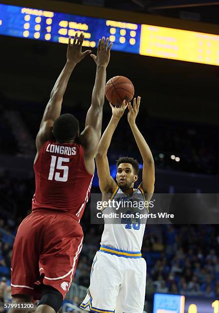 Bruins Jonah Bolden takes a shot over Washington State Cougars Junior Longrus during the game at Pauley Pavilion in Westwood, CA.