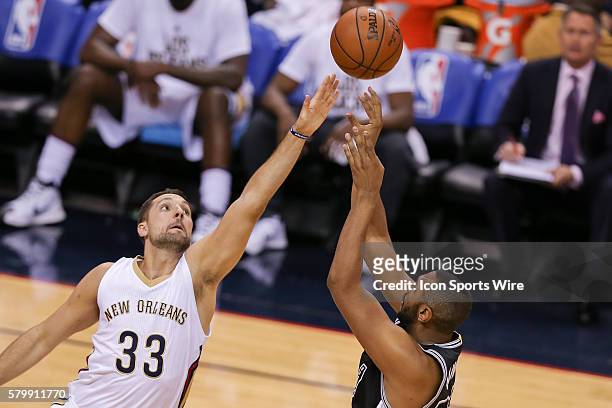 New Orleans Pelicans guard Norris Cole shoots against New Orleans Pelicans forward Ryan Anderson during the NBA game between the San Antonio Spurs...