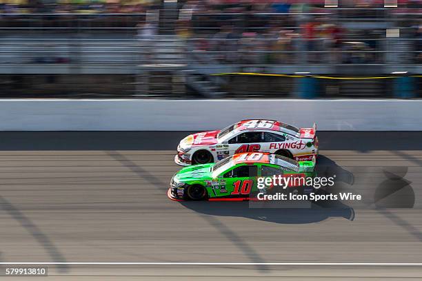 Danica Patrick and Michael Annett race down the straightaway during the NASCAR Sprint Cup Series - Pure Michigan 400, at the Michigan International...