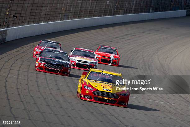 Joey Logano , Cole Whitt , and Michael Annett race into Turn 1 during the NASCAR Sprint Cup Series - Pure Michigan 400, at the Michigan International...