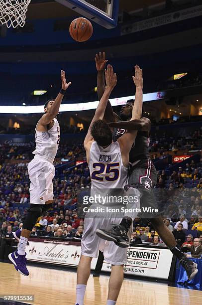 Southern Illinois guard Anthony Beane puts up a shot over Northern Iowa forward Bennett Koch during a Missouri Valley Conference Championship...