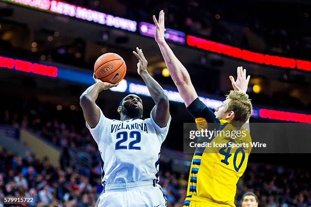 Villanova Wildcats forward JayVaughn Pinkston leans back to shoot over Marquette Golden Eagles center Luke Fischer during the NCAA men's basketball...