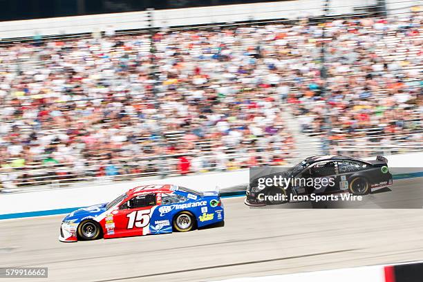 Clint Bowyer, NASCAR Sprint Cup Series driver of the AAA Insurance Toyota and Alex Bowman in the Chevrolet race down the front stretch during the...