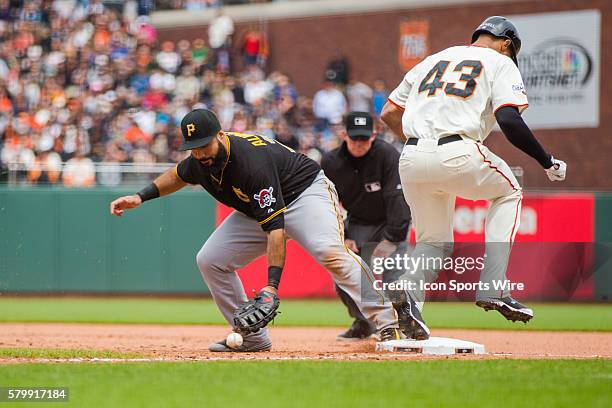 Pittsburgh Pirates first baseman Pedro Alvarez loses control of the ball as San Francisco Giants right fielder Justin Maxwell makes it safely on...