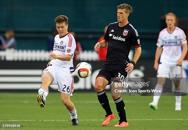 Chicago Fire midfielder Michael Stephens boots the ball past D.C. United forward Conor Doyle during a MLS soccer match at RFK Stadium, in Washington...