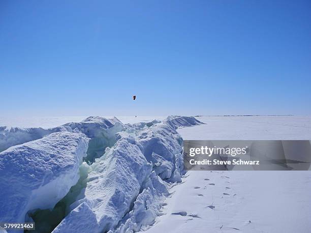 kite skier and ressure ridge on great slave lake - great slave lake stock pictures, royalty-free photos & images