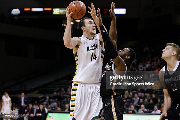 Wright State Raiders center Michael Karena shoots over Milwaukee Panthers guard Akeem Springs during the NCAA Basketball game between the Wright...