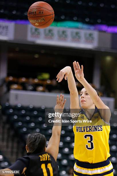 Michigan Wolverines guard Katelynn Flaherty fires up the jump short over Iowa Hawkeyes guard Tania Davis during the Women's Big Ten Tournament game...