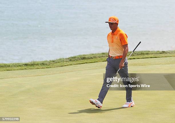 Rickie Fowler walks on to number twelve green after nearly scoring a hole in one during the final round of the PGA Championship at Whistling Straits...