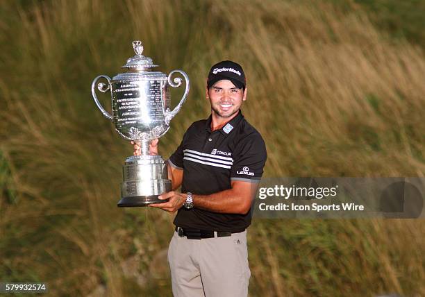 Jason Day, shooting the only 20-under par score in major championship history, smiles and lifts the Wanamaker Trophy after clinching the PGA...