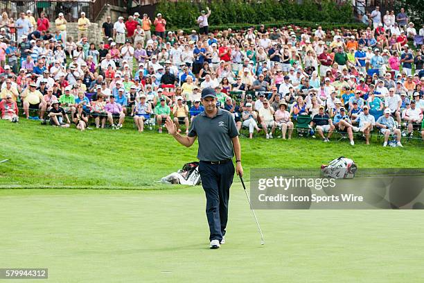 Thomas Aiken acknowledges the gallery surrounding the 18th green at the conclusion of his round during the final round of the Memorial Tournament...