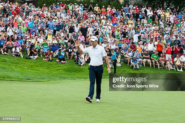 Justin Rose reacts to sinking his par put on the first sudden-death playoff hole during the final round of the Memorial Tournament presented by...