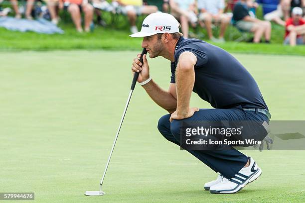 Dustin Johnson lines up his put on the 18th green during the final round of the Memorial Tournament presented by Nationwide Insurance held at...