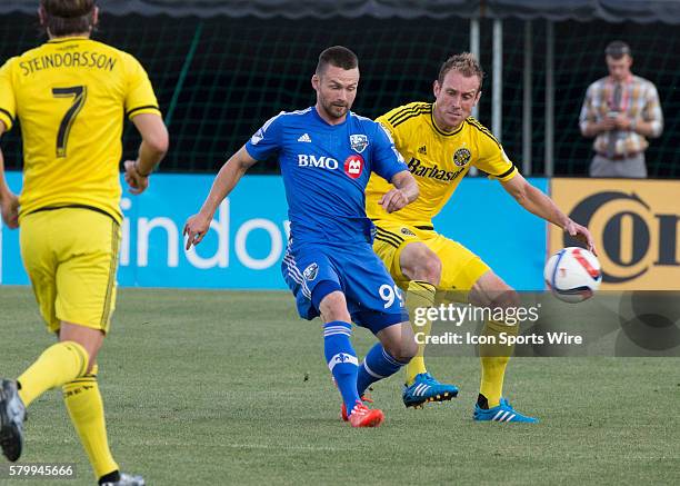 Tyson Wahl of the Columbus Crew SC and Jack McInerney of the Montreal Impact during the game between the Columbus Crew SC and the Montreal Impact...