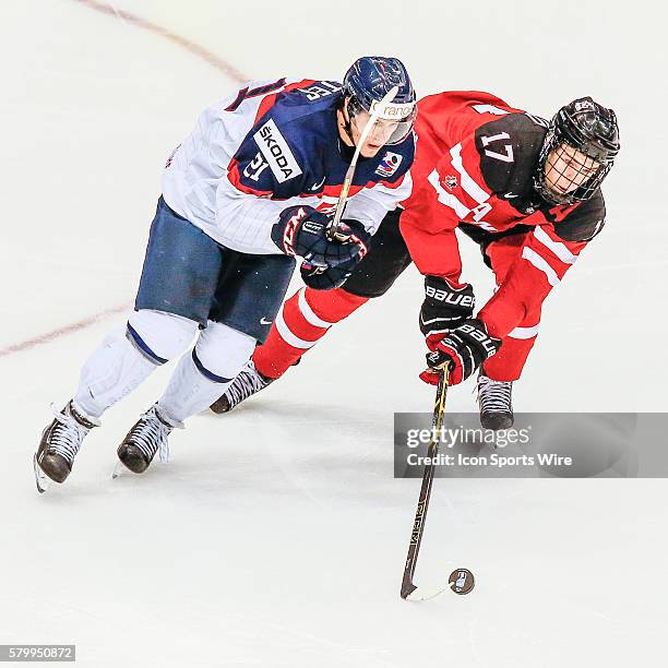 Connor McDavid of Team Canada fights for puck with David Soltes of Slovakia during Canada's 5-1 victory over Slovakia at the IIHF World Junior...