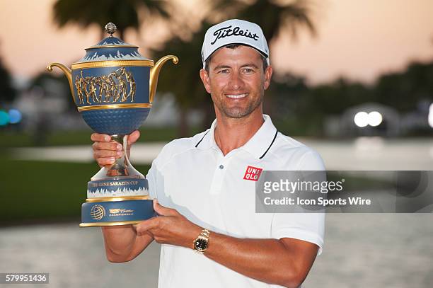 Adam Scott of Australia poses with the trophy on the 18th hole during the final round of the World Golf Championships-Cadillac Championship at Trump...