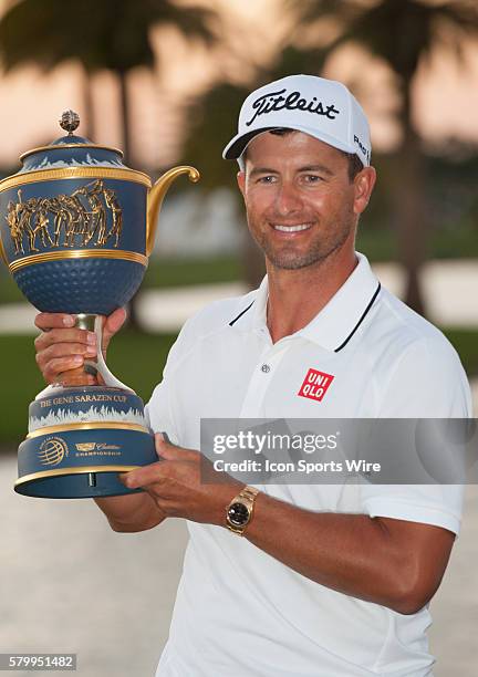 Adam Scott of Australia poses with the trophy on the 18th hole during the final round of the World Golf Championships-Cadillac Championship at Trump...