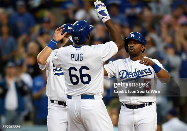 Los Angeles Dodgers Right field Yasiel Puig [9924] is congratulated by his team mates Los Angeles Dodgers Center field Joc Pederson [8776] and Los...