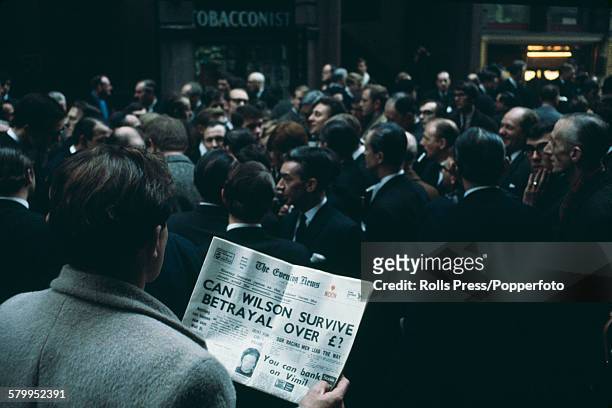 View of traders and workers from the London Stock Exchange standing outside the Capel Court building in the City of London during a period of forced...