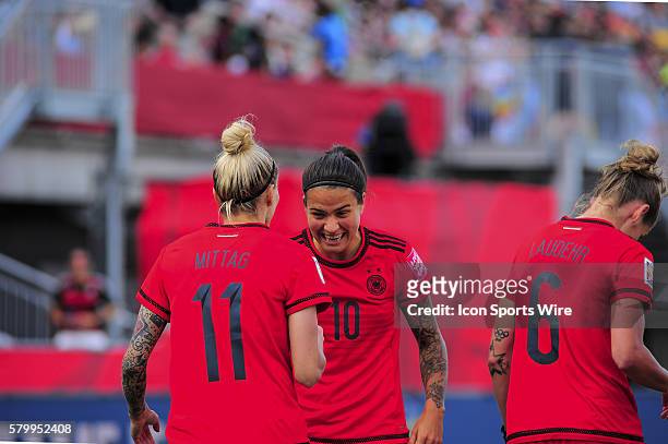 June 11, 2015 - Ottawa, Ontario, Canada Midfielder Dzsenifer Marozsan of Germany congratulates Forward Anja Mittag of Germany after her goal during...