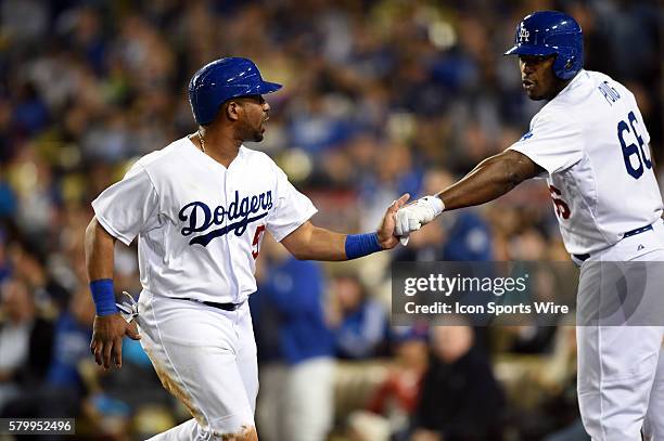 Los Angeles Dodgers Infield Alberto Callaspo [4559] is congratulated by Los Angeles Dodgers Right field Yasiel Puig [9924] after tagging up on a pop...
