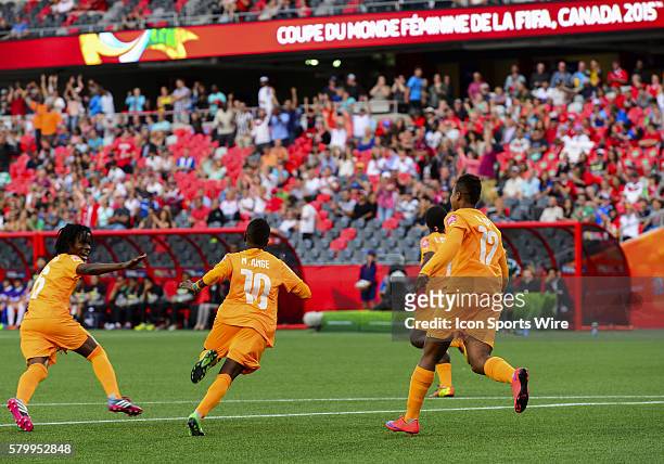Ange Nguessan of Ivory Coast races away to celebrate after scoring the opening goal during the FIFA 2015 Women's World Cup Group B match between...