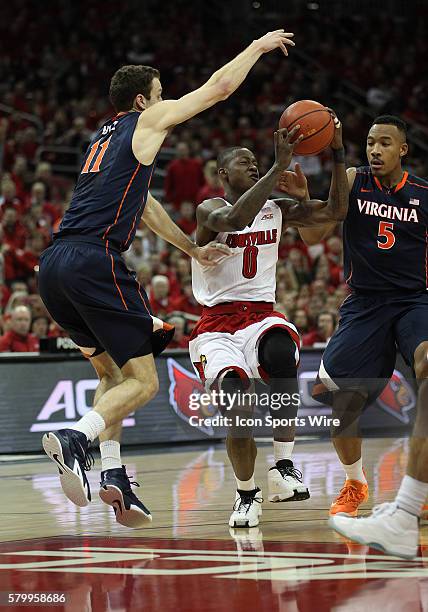 Louisville Cardinals guard Terry Rozier drives the lane against Virginia Cavaliers forward Evan Nolte and forward Darion Atkins in a game between the...