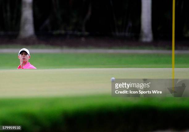 Rory McIlroy of Northern Ireland watches his chip shot during the third round of the World Golf Championships-Cadillac Championship on the TPC Blue...